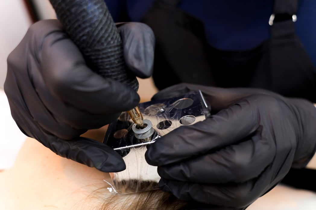 Permanent Makeup Artist Installs Tattoo Pigment in Tattoo Machin